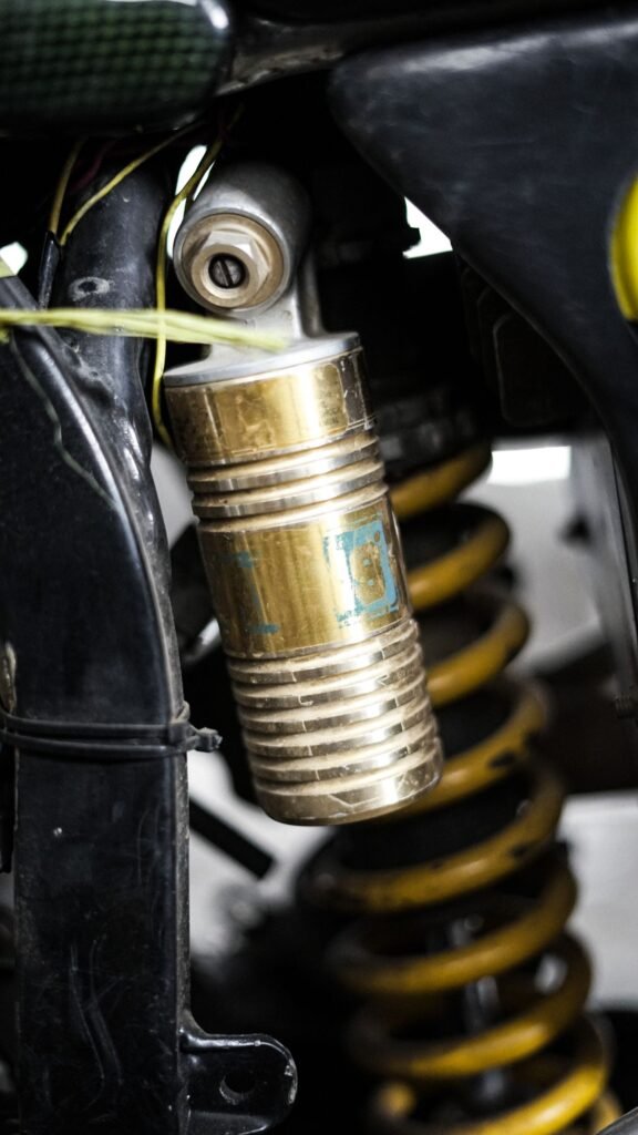 Close-up view of a vehicle suspension coil spring and shock absorber component